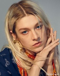 a woman with blonde hair and blue eyes posing for a magazine cover photo by michael walker