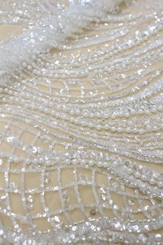 Beaded Embroidery Floral Lace Fabric With Sequins Heavy Beading Bridal Lace Fabric 51 inches Width For Wedding Dress Couture Lace Fabric This lace has an amazing look and is really very heavy. It is perfect the the most unique bridal dresses. Width about: 51inch (130Centimeters) Length : 91 Centimeters/ 1Yard Material: Beads, Sequin,Pearls, Metallic Thread Colors: Off White Price is set for one yard. You will receive the fabric in one continuous piece if you purchase more than 1 yard. Our lace p White Embellished Embroidered Fabric For Banquet, Silver Beaded Embroidered Fabric For Wedding, Beaded Sequin Fabric For Wedding, White Beaded Embroidered Fabric For Wedding, White Beaded Sequin Fabric For Wedding, White Pearl Embroidered Fabric For Banquet, White Beaded Wedding Dress For Party, Silver Sequin Fabric With Pearl Embroidery For Wedding, Unique Bridal Dresses