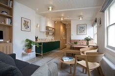 a living room filled with furniture next to a window