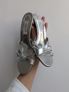 These stylish vintage silver leather straps sandals by Together feature sleek wooden heels, offering both comfort and trend-worthy appeal. In good condition, these sandals are the perfect blend of elegance and everyday wearability, making them a versatile choice for any wardrobe.   Era: 1990s - early 2000s Measurements: 25 x 8.5  inches, 8 cm heel Sandals With Straps, Straps Sandals, Wooden Heels, Leather Strap Sandals, Wooden Heel, Early 2000s, Strap Sandals, Vintage Silver, Women's Shoes Sandals