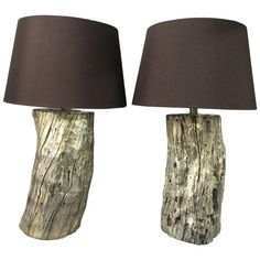 two lamps made out of tree trunks with shades on them