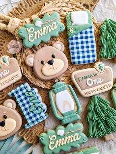 decorated cookies in the shape of teddy bears and christmas trees on a wicker basket