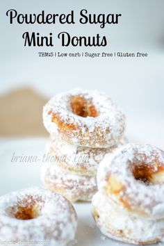 powdered sugar mini donuts on a white plate with text overlay that reads, powdered sugar mini donuts