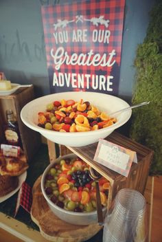 there are many different types of food on the table in front of this sign that says, you are our greatest adventure