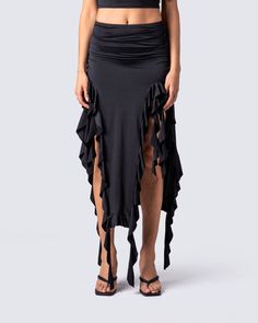 Owning an entire room has never been easier 😏 Rock your darker side with this sultry black jersey skirt. Complete with a high-waisted fit, shirring at the waist and hips, and front cutout detailing with a cascading ruffle hem 🖤 Fitted Long Skirt Bottoms With Ruched Sides, Fitted Long Skirt With Ruched Sides, Flowy Ruched Skirt In Elastane, High Waist Ruched Skirt For Party, Stretch Asymmetrical Draped Skirt For Night Out, Black Fitted Elastane Maxi Skirt, Fitted Black Elastane Maxi Skirt, Asymmetrical Draped Skirt For Night Out, Stretch Asymmetrical Skirt With Ruched Sides