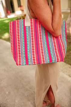 Elevate your style with our Enjoy The View Tote Bag! This stunning tote features a unique and eye-catching pattern that is sure to turn heads. Perfect for carrying all your essentials while making a chic statement. Order now and enjoy the view in style! Limited quantities available, secure your bag today! Every bag is unique and colors may vary. -100% Viscose -Spot Clean -Shoulder Straps -Measurements: L 14" W19" H 3.4" Trendy Vacation Bag With Top Carry Handle, Trendy Large Capacity Red Beach Bag, Trendy Red Beach Bag With Large Capacity, Large Capacity Multicolor Vacation Bags, Trendy Red Rectangular Beach Bag, Large Capacity Multicolor Bags For Vacation, Trendy Vacation Bags With Removable Pouch, Trendy Square Beach Bag For Shopping, Trendy Tote Beach Bag For Shopping