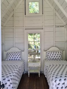 two beds in a small room with white walls