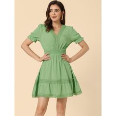 Cut to an elegant fit-and-flare style, this mini dress is sure to serve you well on summer days. The dreamy solid color and a ruffled tiered hem bring casual romance to this puff-sleeved dress. Indulge in the fanciful frills on this vacation-ready dress. It is fashioned with a signature v-neck, a crochet trim, and a layered skirt. Mini and flowy, this gorgeous dress is detailed with bubble sleeves, and a lace panel, for a peasant look, which is sure to elevate your beach-day looks. Fit And Flare Mini Dress For Spring, Smocked Bodice Fit And Flare Mini Dress, Solid Summer Mini Dress With Ruffle Hem, Solid Color Summer Mini Dress With Ruffle Hem, Mini Dress With Smocked Back In Specific Color, Knee-length Summer Mini Dress, Green Fit And Flare Mini Dress For Summer, Green Mini Dress With Smocked Bodice, Solid Color Knee-length Summer Mini Dress