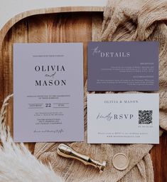 the wedding stationery is laid out on top of a wooden tray with furnishing