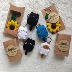 four keychains made to look like sheeps with sunflowers on them