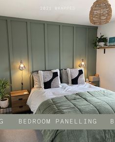 a bedroom with green paneling and two lamps on either side of the headboard