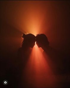 two people with their faces obscured by the light