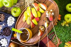 apples, marshmallows, and other snacks are arranged on a platter