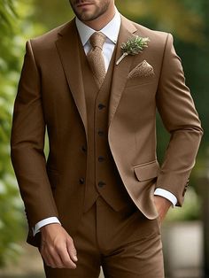 a man in a brown suit with a flower on his lapel