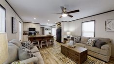 a living room filled with furniture next to a kitchen and dining area in a home