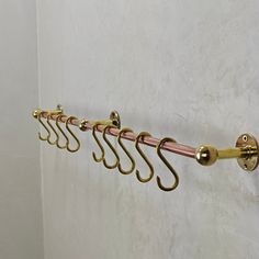 a row of hooks hanging on the side of a wall