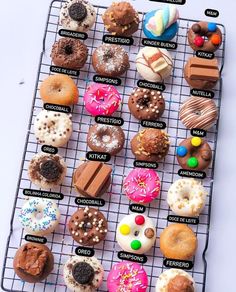 there are many different types of donuts on the rack with words in each one