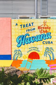 there is a sign on the side of this building that says, a treat from havana club