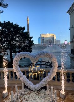 a heart - shaped wreath with the eiffel tower in the background