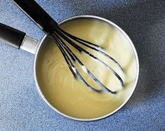 an image of whisk in a saucepan with liquid on the counter top