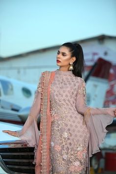 Elegant Pakistani Eid dress, Features geometrical pure thread embroidery all over the shirt with lavish cutwork border along with hanging thread lace and beautiful ban neckline. Fully embellished umbrella cut sleeves all work on pure chiffon fabric with high-quality inner. Dupatta: It comes with vibrant contrast tea pink full embellished chiffon dupatta with Two-sided heavy cutwork border along pearls and crystal hanging tassels and two-sided hemline detailing. Bottom: Pair with matching Lavende Hanging Tassels, Eid Dress, Embellished Shirt, Soft Lavender, Eid Dresses, Party Pants, Pure Chiffon, Thread Embroidery, Lavender Color