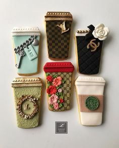 six decorated cookies in the shape of coffee cups and purses with flowers on them