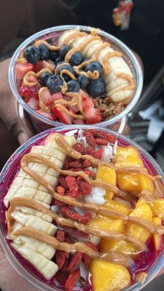 two bowls filled with different types of fruit on top of each other and drizzled in peanut butter