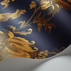 a gold and black wallpaper with an intricate design on it's side,