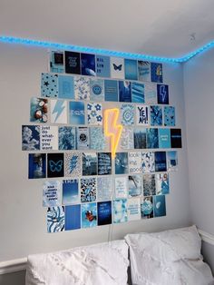 a bed room with a neatly made bed and a wall covered in pictures on it