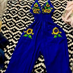 Mexican Romper Embroidered By Hand Handcrafted W Vintage Indigenous Techniques Handmade Stitched Using The Best Materials High Quality Fabric And Threads For Crochet Details Ans Colorful Embroidery. Authentic Traditional Vintage Mexico Style. Navy Blue Color Sunflowers Size: L Embroidered Yellow Cotton Bottoms, Yellow Embroidered Cotton Bottoms, Embroidered Cotton Jumpsuits And Rompers For Spring, Spring Embroidered Fitted Jumpsuits And Rompers, Embroidered Fitted Jumpsuits And Rompers For Spring, Blue Cotton Jumpsuits And Rompers For Vacation, Sleeveless Embroidered Jumpsuits And Rompers For Summer, Yellow Embroidered Summer Bottoms, Yellow Embroidered Bottoms For Summer