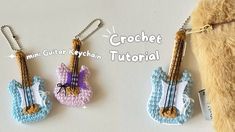 crochet guitar keychains are hanging from chains