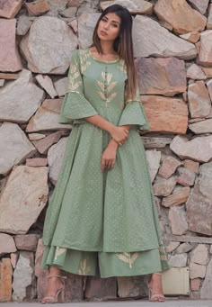 Readymade Cotton Pakistani Suit in Dusty Green This Round Neck and Quarter Sleeve attire with Cotton Lining is Prettified with Block and Golden Print Available with a Dusty Green Cotton Plazzo and a Dusty Green Cotton Dupatta The Kameez and Bottom Lengths are 50 and 37 inches respectively Do note: The Length may vary upto 2 inches. Accessories shown in the image are for presentation purposes only.(Slight variation in actual color vs. image is possible). Pakistani Suit, Pakistani Designer Suits, Dusty Green, Indian Gowns Dresses, Kurti Designs Party Wear, Indian Gowns