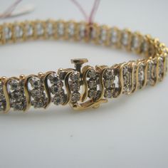 "For sale: (1) d923 Stunning 14kt Yellow Gold Diamond Tennis Bracelet PLEASE READ ENTIRE DESCRIPTION BEFORE PURCHASING Pre-owned item. Good condition. Please see pictures for details. Sold as is, as seen on pictures. This bracelet contains 132 diamonds, all of which are round cut. It is not stamped, but has been tested for authenticity. Specifics: 14k Yellow gold Hook clasp Diamonds: 1.98cts total Length: 7 inches Width: 8 mm Total Weight: 19.6 grams Please be 100% sure of your purchase before b Diamond Tennis Bracelet, Wedding Jewelry Bracelets, Tennis Bracelet Diamond, Hook Clasp, Cut It, Wedding Bracelet, Tennis Bracelet, See Picture, Diamond Bracelet