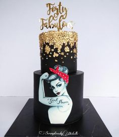 a black and gold cake with an image of a woman on it