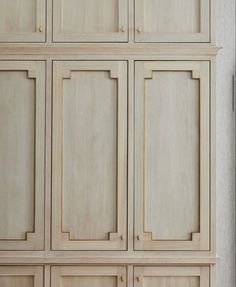 a large wooden cabinet with many doors and drawers