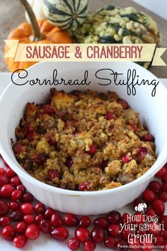 sausage and cranberry cornbread stuffing in a white bowl surrounded by cranberries