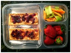 a plastic container filled with fruit and pastries