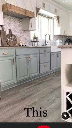 a kitchen with gray cabinets and white counter tops