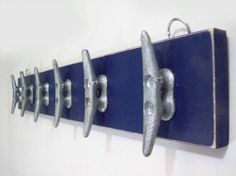 three metal hooks are attached to a wall