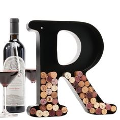 a bottle of wine next to a wooden letter with corks