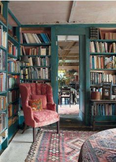 a room filled with lots of books and furniture