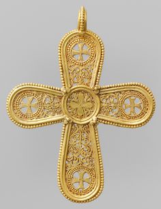 an ornate gold cross with intricate filigrees