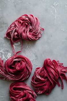 some red yarn is laying on a table and it looks like they have been dyed