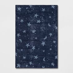 a blue rug with stars and moon designs on the front, against a white background