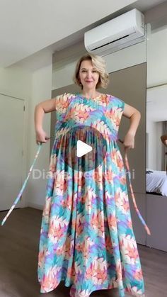 a woman in a colorful dress is dancing