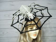 "Perfect for Halloween! This is a unique huge spider skeleton on a black tinsel web. The spider is a hard plastic and he is 8\"x15\" the spider web is a plastic base wrapped in black tinsel. The web measures about 15\" across. This is on a headband. Is it heavy? Yes, a little heavy. You will need to secure with some bobby pins at the base of the headband. I will include them in your package.  The spider and web slides on the headband for your perfect placement. Please ask any questions you may have as I do not take returns and all sales are final. Thank you for stopping by.  All sales are final..no exchanges or returns. Check out my other hats and fascinators. https://www.etsy.com/shop/MsPurdy I ship Priority mail within the U.S. I ship many times a week." Spooky Halloween Costume Hats And Headpieces, Black Horror Costume Accessories For Themed Events, Spider Hat, Spider Skeleton, Huge Spiders, Creepy Spider, Hair Net, The Spider, Halloween Spider