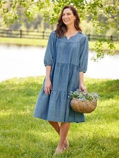 We took one of our most popular muumuu styles and made it out of our exceptionally soft cotton denim for a casual dress you can wear anywhere. It has a roomy, tiered style, relaxed fit, and flattering silhouette. Details include a soft round neckline with a flattering V-notch, 3/4 sleeves with elasticized cuffs, and side-seam pockets. This item runs large; please order one size down to ensure the best fit. Flowing tiers of soft denim Round neckline with V-notch 3/4 sleeves with elasticized cuffs Indigo Cotton Dress With Relaxed Fit, Indigo Relaxed Fit Cotton Dress, Dark Wash Relaxed Fit Cotton Dress, Denim Blue Relaxed Fit Chambray Dress, Chambray Dress With Relaxed Fit For Day Out, Indigo Washed Dresses For Spring, Spring Indigo Washed Dress, Relaxed Fit Chambray Dresses In Medium Wash, Washed Blue Cotton Denim Dress For Day Out