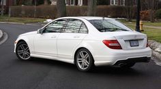 a white car is parked on the street