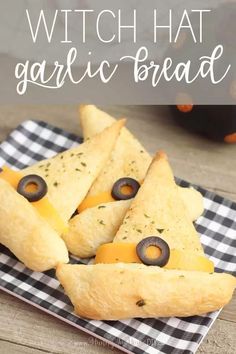 cheese and black olives are on top of cheesy crackers with the words, witch hat garlic bread