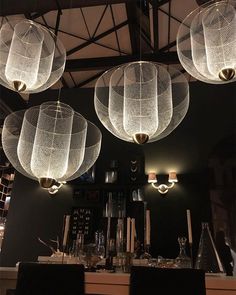 several lights hanging from the ceiling in a restaurant